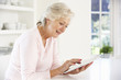 © Monkey Business - Senior woman using tablet at home