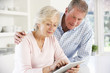 © Monkey Business - Senior couple using tablet at home