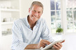 © Monkey Business - Senior man using tablet at home