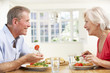 © Monkey Business - Retired couple enjoying meal at home