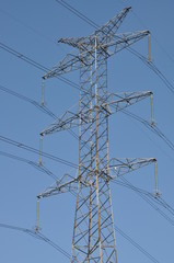 Power transmission tower against blue sky