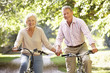 © Monkey Business - Senior couple cycling in park