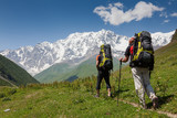 Fototapeta Las - Hikers in Caucasus mountains of Zemo (upper) Svaneti, Georgia