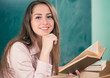 smiling teacher with open book