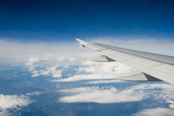 Fototapeta Niebo - Airplane wing out of window