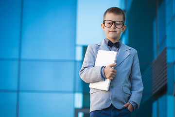 kid with laptop on the blue modern background