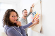 © Production Perig - Young couple choosing colors of their wallpaper