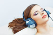Young woman home portrait. Sleeping girl with headphones.