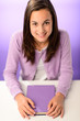 © CandyBox Images - Smiling student girl sitting behind desk purple