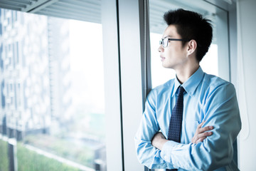 Wall Mural - Portrait of a businessman looking at the window