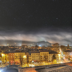 Wall Mural - night sky above mountains in trento, northern italy.
