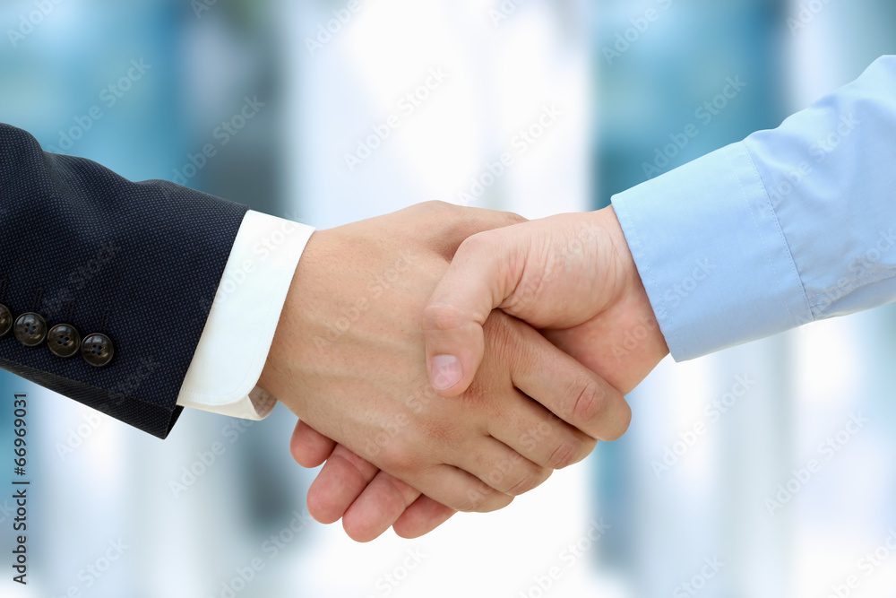 Close-up image of a firm handshake  between two colleagues