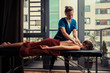 © LoloStock - Massage therapist treating patient at home