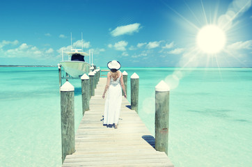 Wall Mural - Girl on the wooden jetty. Great Exuma, Bahamas