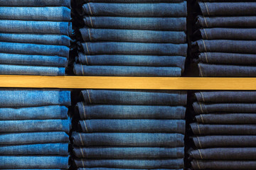 Wall Mural - Neat stacks of folded jeans on the shop shelves