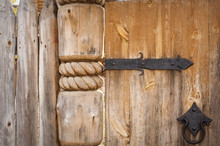 Close-up Of Old Wooden Door On Metal Hinges