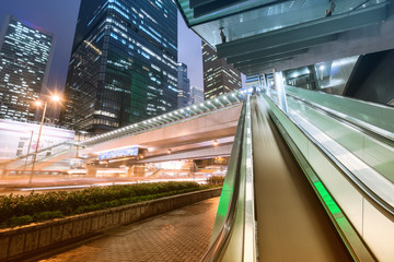 Wall Mural - the light trails on the modern building background in hongkong c