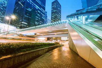 Wall Mural - the light trails on the modern building background in hongkong c