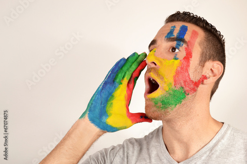Fotografie, Obraz Young man screaming with hand painted face