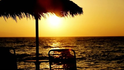 Sticker - sunbed and parasol on the beach, sunset.