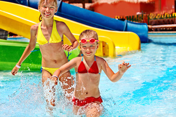 Children on water slide at aquapark.