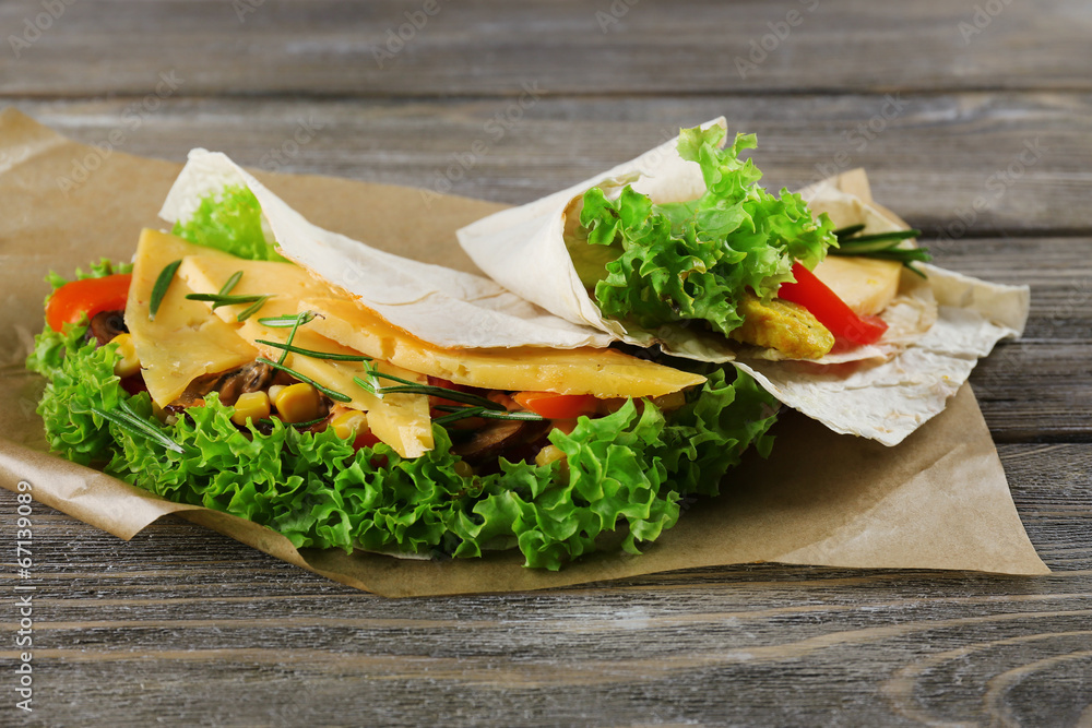 Veggie wrap filled with cheese and fresh vegetables