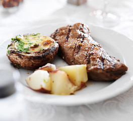 Wall Mural - grilled strip steak with potatoes and stuffed mushroom