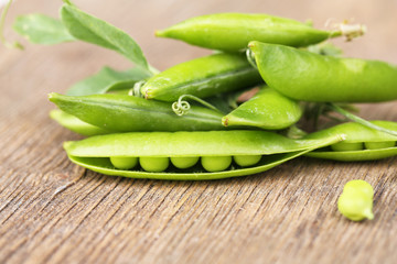 Fresh green peas on wooden table