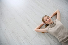 Upper View Of Smiling Woman Relaxing Laid On Floor