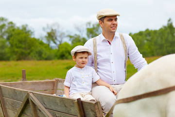 Wall Mural - farmer family riding a horse cart