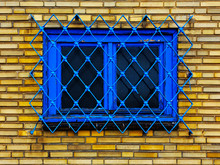 Old Barred Window In Brick Wall