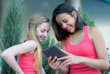 Two teen girls with tablet PC