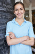 © highwaystarz - Waitress In Restaurant Writing Menu On Blackboard
