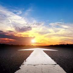 Empty asphalt road at sunset