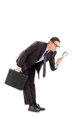 Poster - Displeased businessman looking through a magnifier