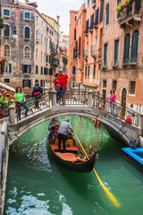 Tourists travel on gondolas at canal