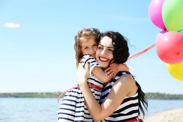 Happy mom and daughter on the beach