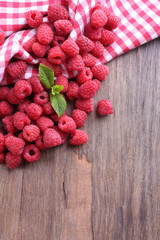 Ripe sweet raspberries on table close-up