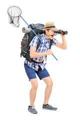 Wall Mural - Guy with butterfly net looking through binoculars