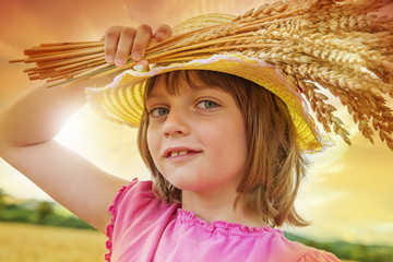 Wall Mural - little girl holding wheat