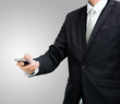 © sorapop - Businessman standing posture hand hold phone isolated