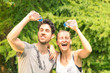 Sporty couple refreshing with water after run training in park