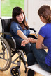 © Photographee.eu - Girl on wheelchair talking with female friend