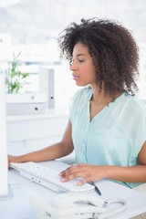 Wall Mural - Casual businesswoman working at her desk