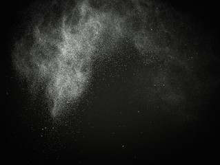 Wall Mural - white powder exploding isolated on black