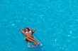 © Netfalls - A girl is relaxing in a swimming pool