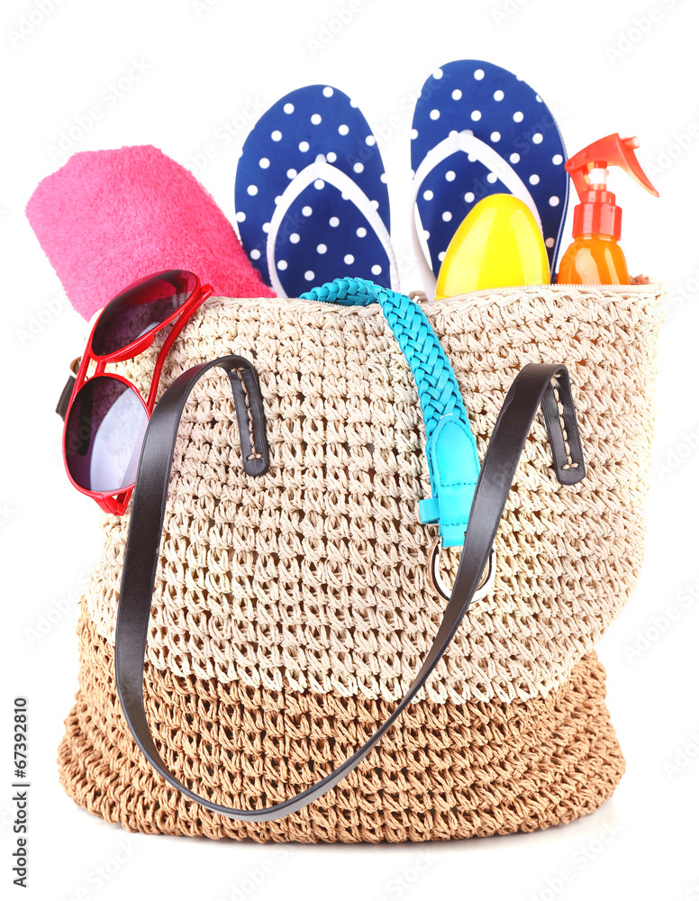 Summer wicker bag with accessories, isolated on white