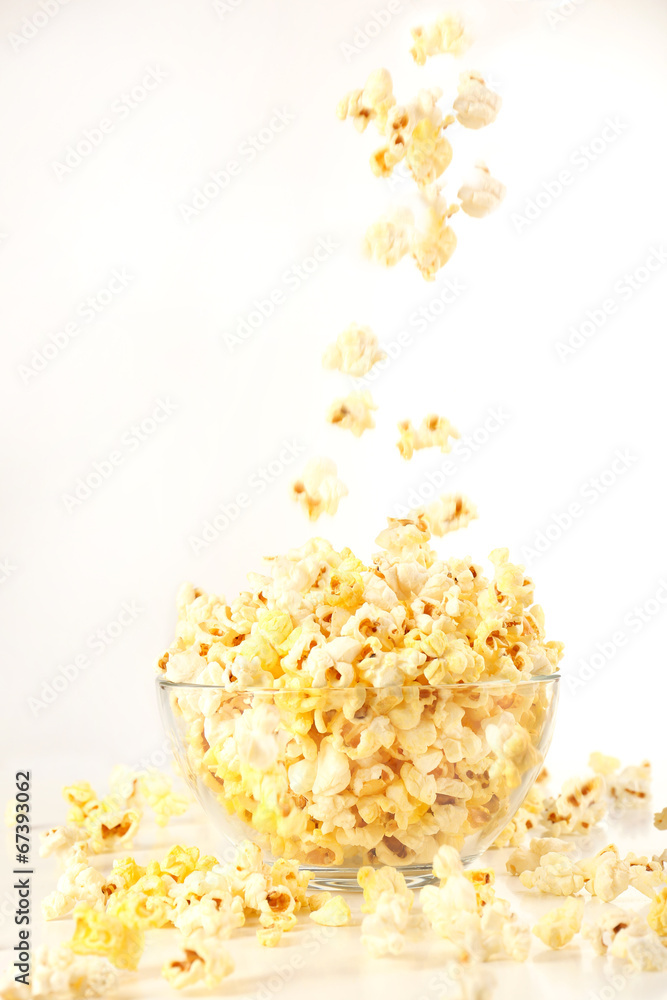 Popcorn in glass bowl isolated on white