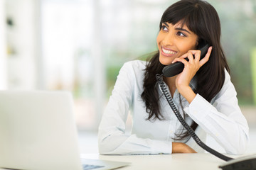 indian office worker talking on the phone