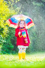 Wall Mural - Little sweet girl playing in the rain